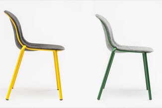 Twee moderne stoelen met grijze stoffering en metalen poten in geel en groen, weergegeven vanaf de zijkant tegen witte achter