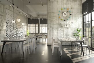 Modern kantoor met grijze betonlook wanden, zwarte eettafels, witte stoelen, hangende verlichting en kleurrijke wandklok met