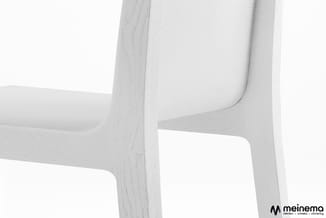 Witte houten stoel met gebogen rugleuning en uitgesneden zijkanten, detail van structuur en constructie.