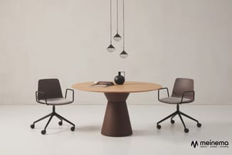 Ronde houten vergadertafel met bruine conische voet, twee bruine kantoorstoel met wieltjes, drie hanglampen en zwarte decorat