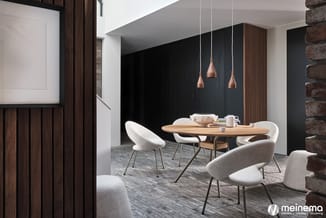 Moderne vergaderruimte met ronde houten tafel, witte stoelen, koperen hanglampem en zwarte wand met houten accenten.