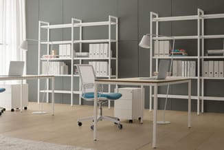 Modern kantoor met twee houten bureaus, witte stellingkasten, blauwe bureaustoelen, witte tafellampen en grijze wand.