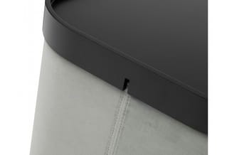 Donkergrijs akoestisch paneel met beige stofbekleding en zwarte ophangbeugel tegen witte muur.