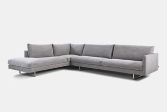 Grijze hoekbank met chaise longue, textielupholstering, metalen poten, op neutrale achtergrond.