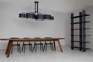 Moderne kantoorinrichting met houten vergadertafel, zwarte stoelen, zwart hangende plafondlicht en zwart wandrek.