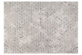 Grijze vloerafwerking met geometrisch sterrenpatroon en gespikkelde textuur.