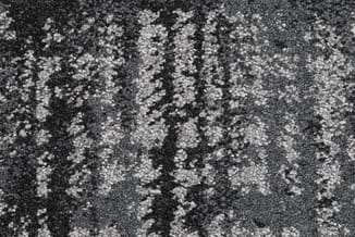 Grijze stof textuur met witte spikkels en donkere verticale strepen, mogelijk tapijt of bekleding materiaal.
