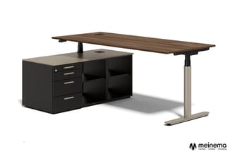 Elektrisch instelbaar bureau met donkergrijs blad, beige onderstel en zwarte kastunit met laden en open vakken.