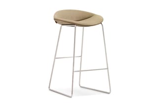 Barkruk met beige gewatteerde zitting en chromen metalen frame met voetsteun, tegen witte achtergrond.