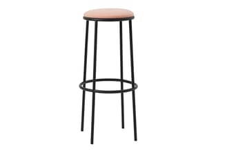 Barkruk met roze/terracotta zitting en zwart metalen frame, voetsteun, minimalistisch design.