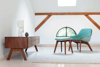 Moderne lounge met turquoise fauteuil, houten bijzettafel, beige tapijt en dakramen in minimalistisch interieur.