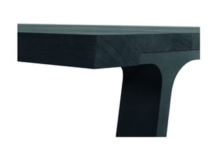 Hoekdetail van grijsgroen en zwart houten tafelblad met diagonale houtnerf textuur en zwart onderstel.