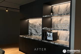 Moderne keukenkasten zwart met marmeren werkblad en achterwand, verlicht met led-strips, koffiemachine en wijnglazen zichtbaa