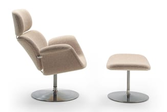 Beige stoftoelen: draailounge met hoofdsteun en bijpassende voetenbankje op chromen voetstukken.