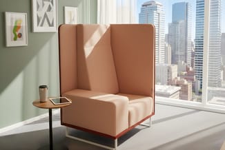 Roze/terracotta akoestische loungepod met hoge zijwanden, wit onderstel, in moderne kantooromgeving met ramen en staande tafe