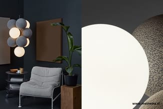 Moderne kantoorhoek met grijze fauteuil, zwarte bijzettafel met plant, hangende bolvormige verlichting in grijs en wit, en br
