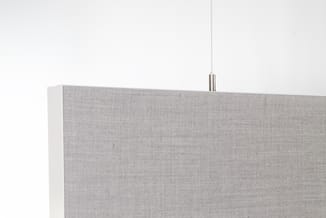 Grijze stofbespanning akoestisch scherm met witte zijkant, opgehangen aan metalen beugel tegen witte muur.