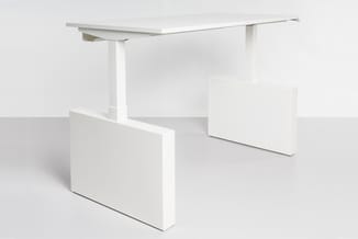 Wit elektrisch verstelbaar bureau met een stijl frame en bijpassend wit kastje, getoond in een minimalistisch kantoorinterieu