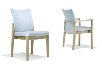 Twee houten stoelen met lichtblauwe textielkussens. Links zonder armleuningen, rechts met houten armleuningen. Beide hebben r