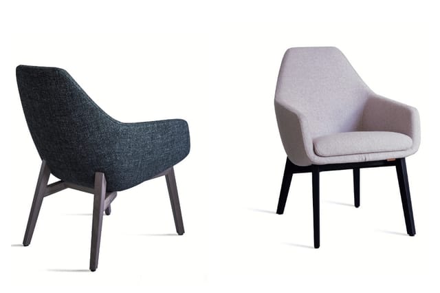 Twee moderne fauteuils: links donkerblauwe stofbekleding, rechts lichtpaarse stofbekleding, beide met zwarte houten poten.