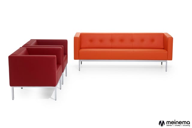 Drie bordeauxrode fauteuils en een oranje bank met knopstiksels op zilveren poten tegen witte achtergrond.