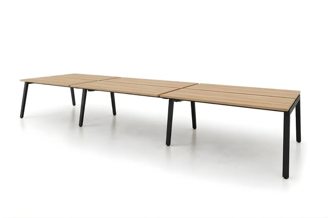Lange vergadertafel met licht houten blad en zwart metalen poten, bestaande uit drie modulaire delen aan elkaar gekoppeld.