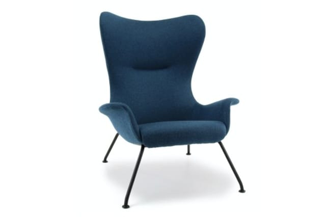 Blauwe fauteuil met hoge gebogen rugleuning, armleuningen en zwart metalen poten op wit oppervlak.