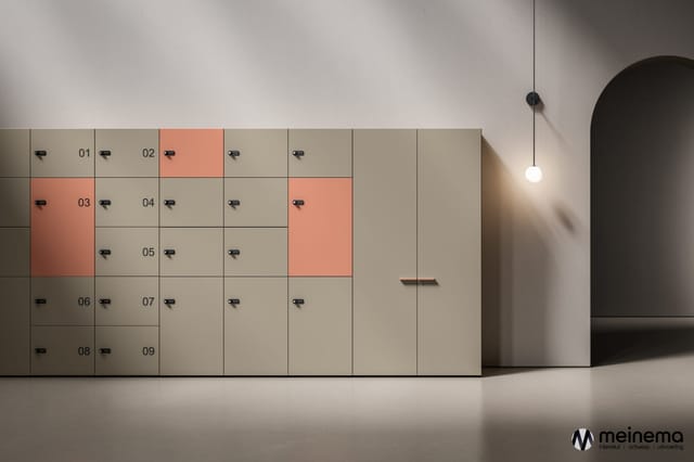Wandmontagesysteem met nummering 01-09, enkele vakken in terracotta-oranje, zwarte handgrepen, in minimalistische ruimte met